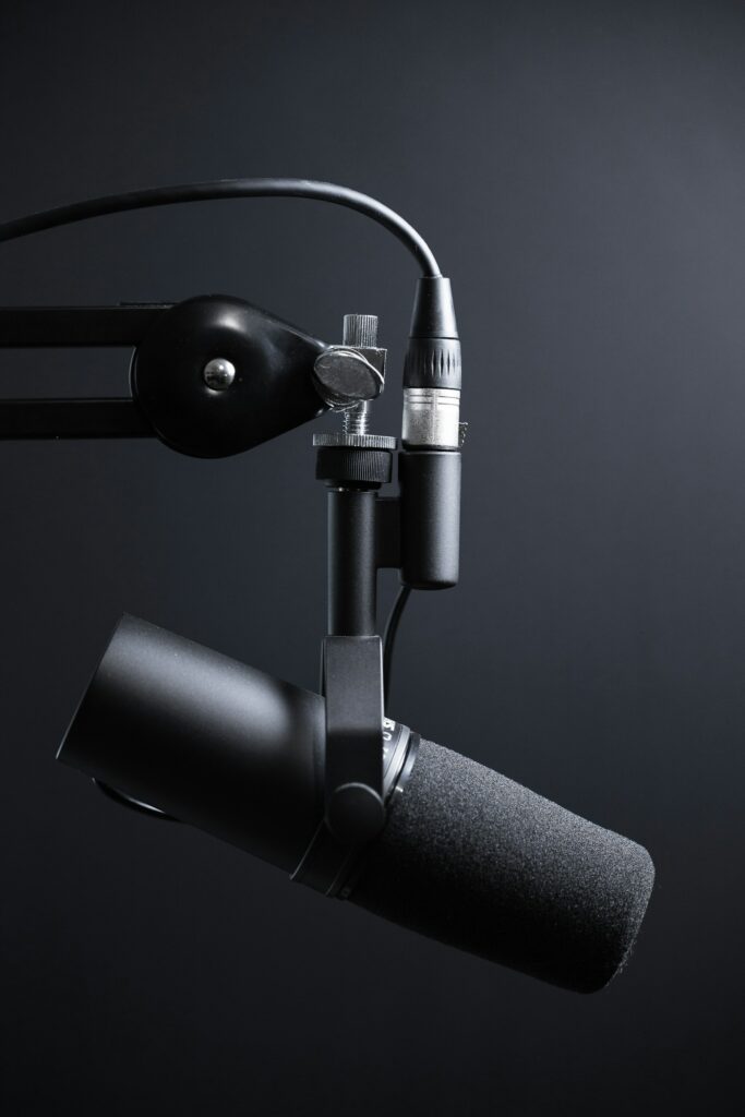 Community radio host recording a podcast in a small studio